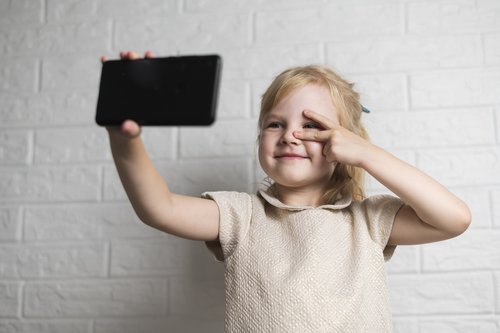 Kita-Kind fotografiert ein Selfie